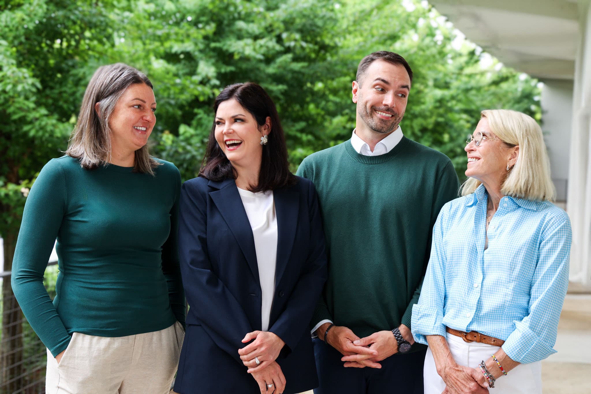 Four LifePlans team members smiling together outdoors