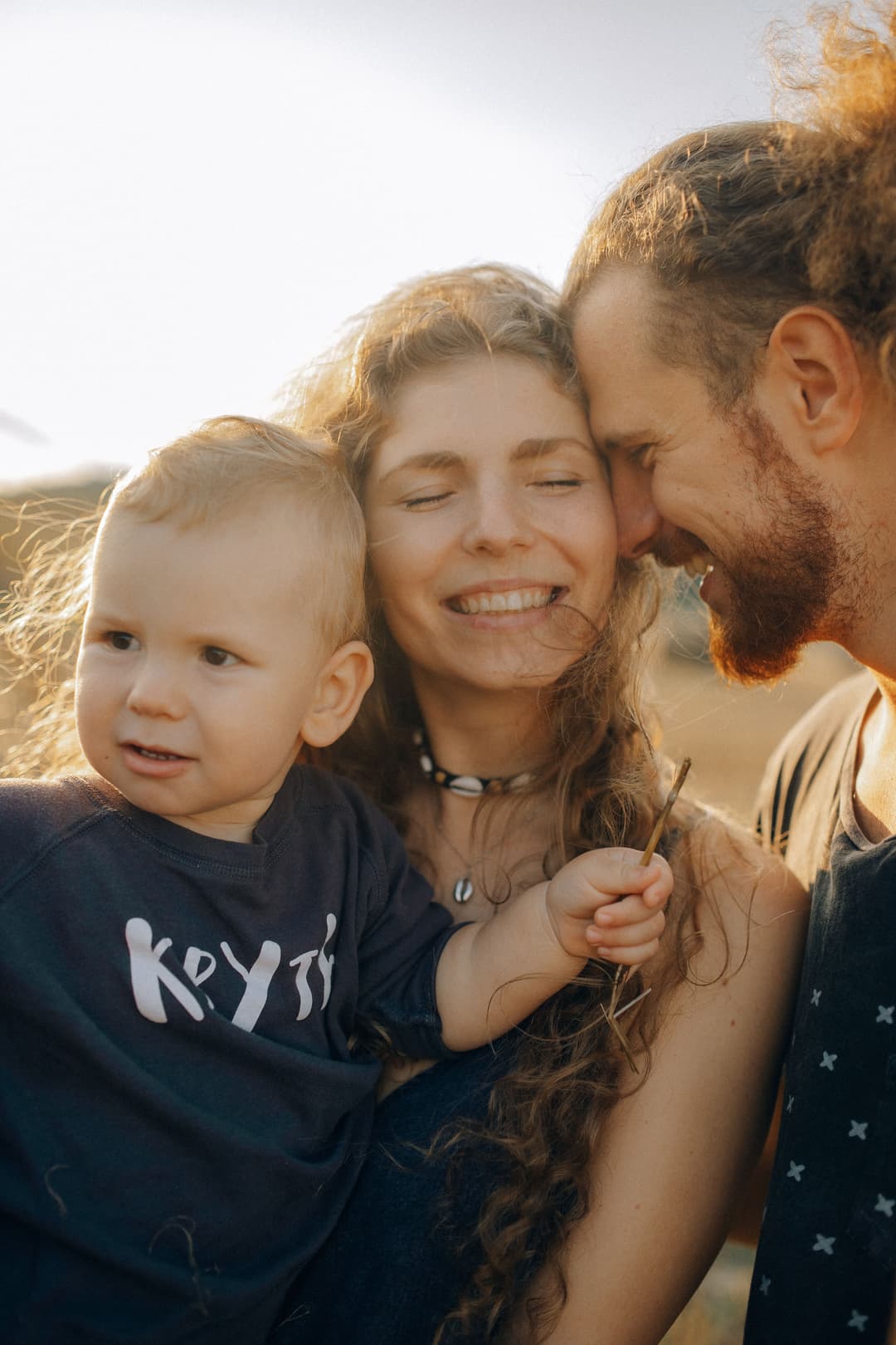 A family together outdoors, surrounded by life moments: centralizing family assets, welcoming a child, planning for retirement, organizing family documents